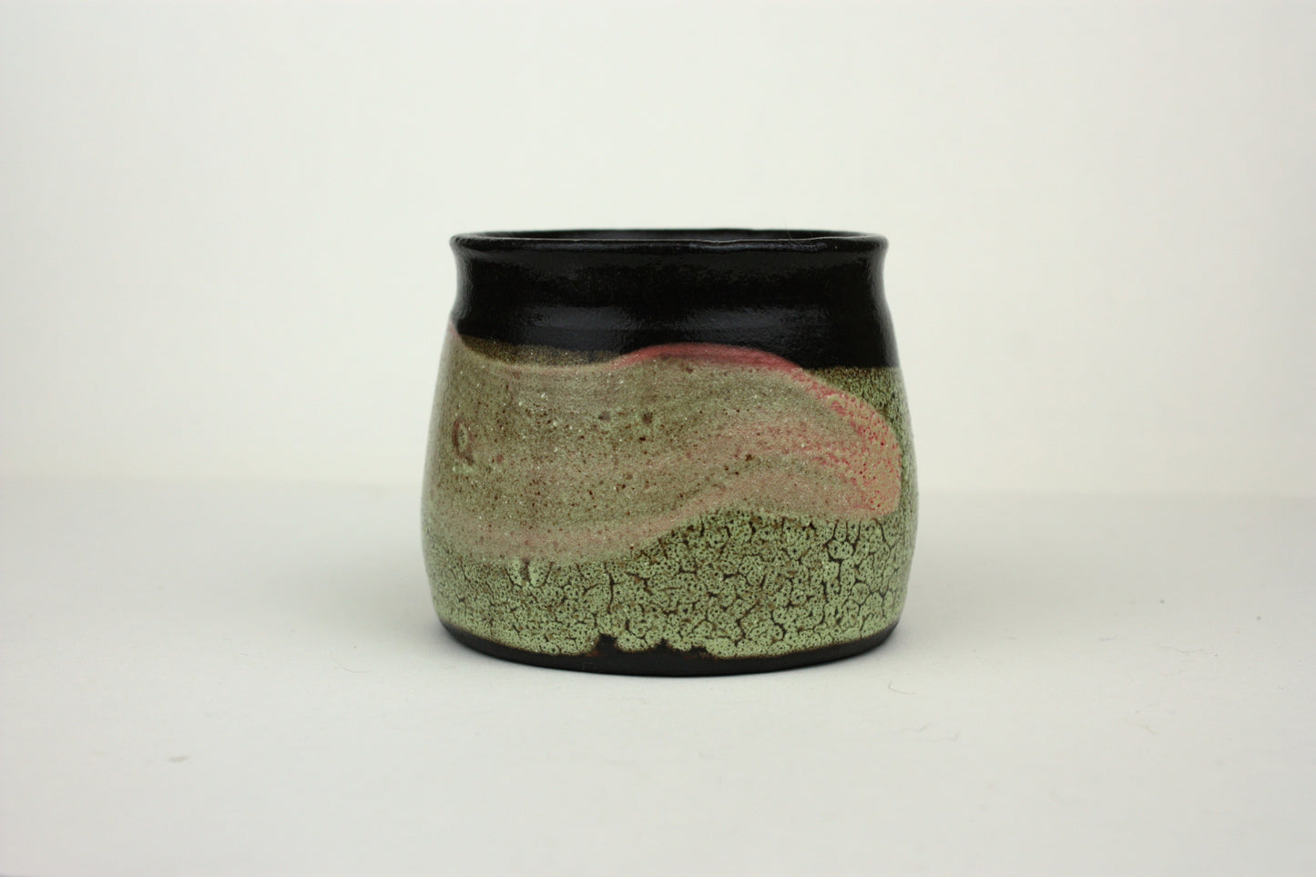 Green crawl glaze mug with pink detail