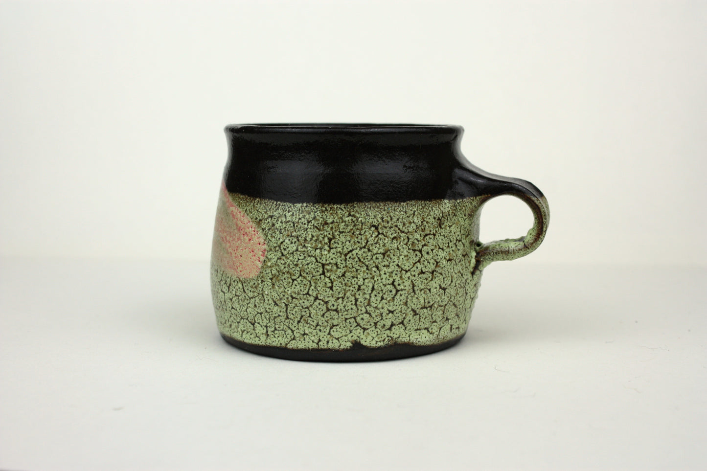Green crawl glaze mug with pink detail