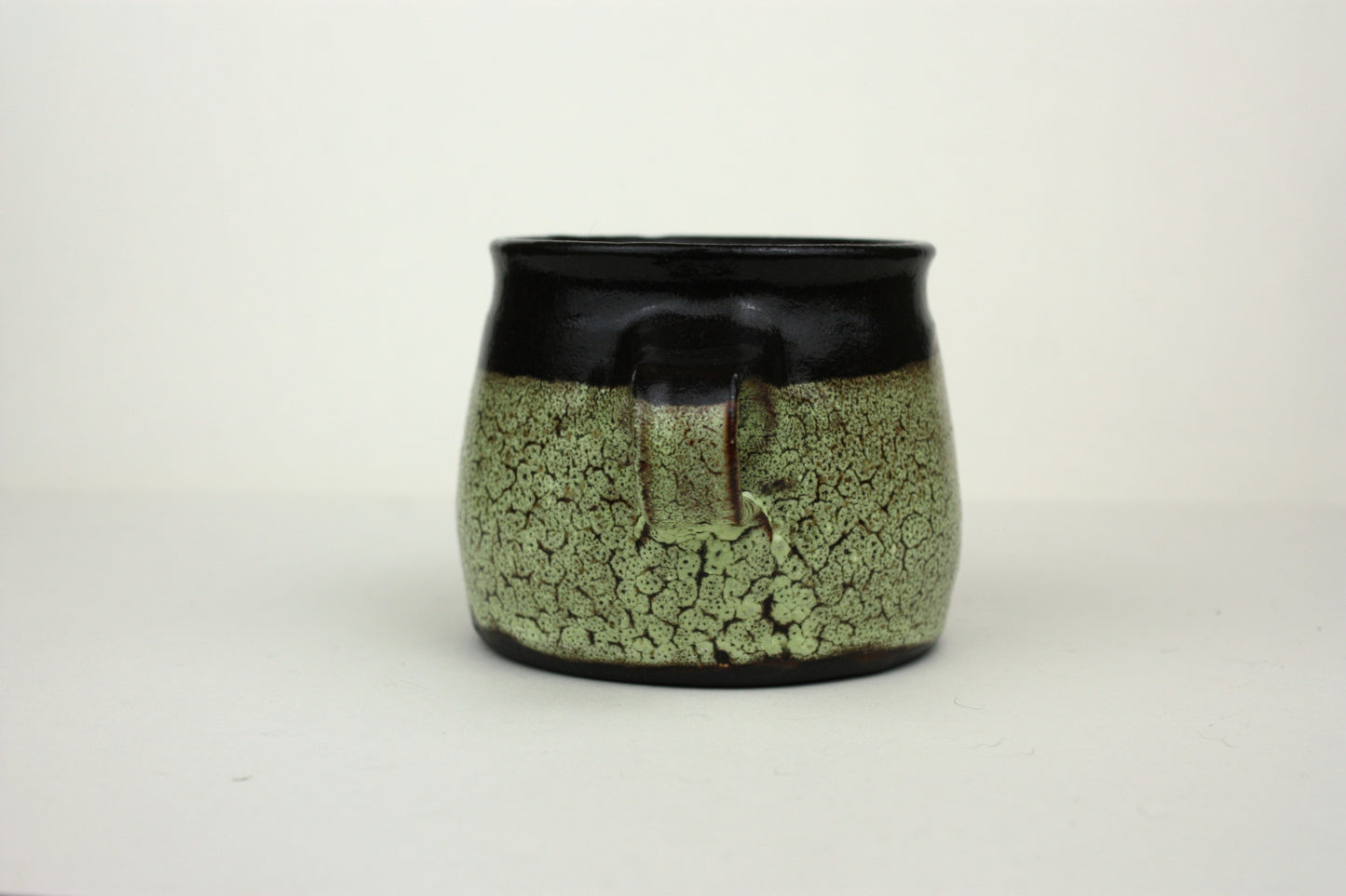 Green crawl glaze mug with pink detail