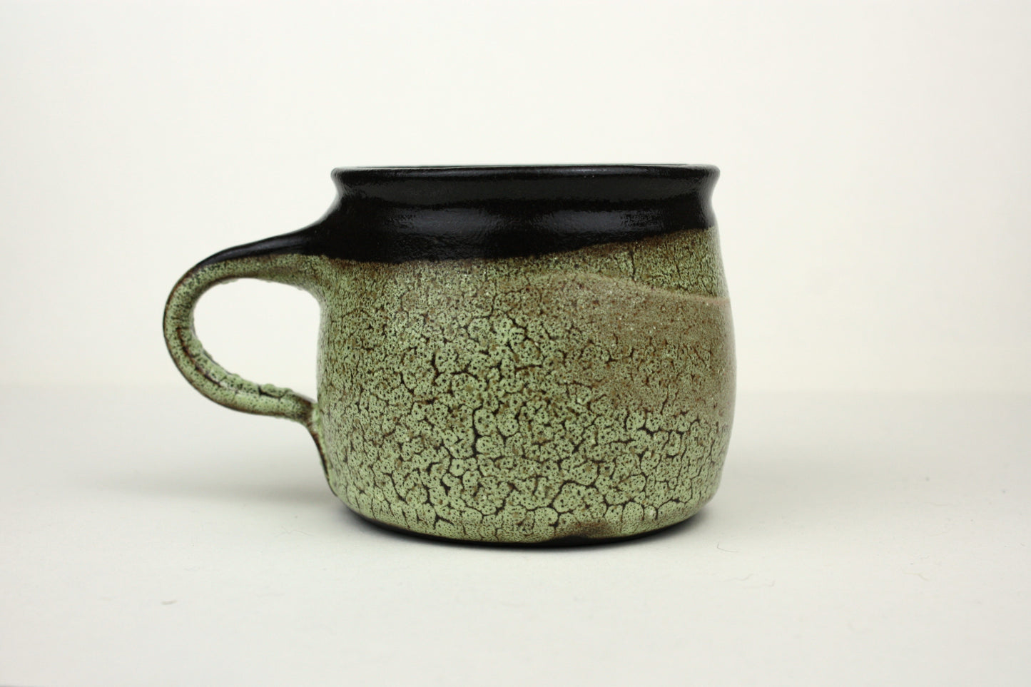 Green crawl glaze mug with pink detail