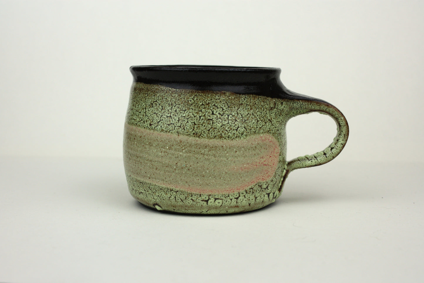 Green crawl glaze mug with pink detail