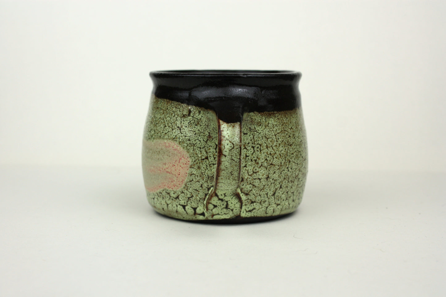 Green crawl glaze mug with pink detail