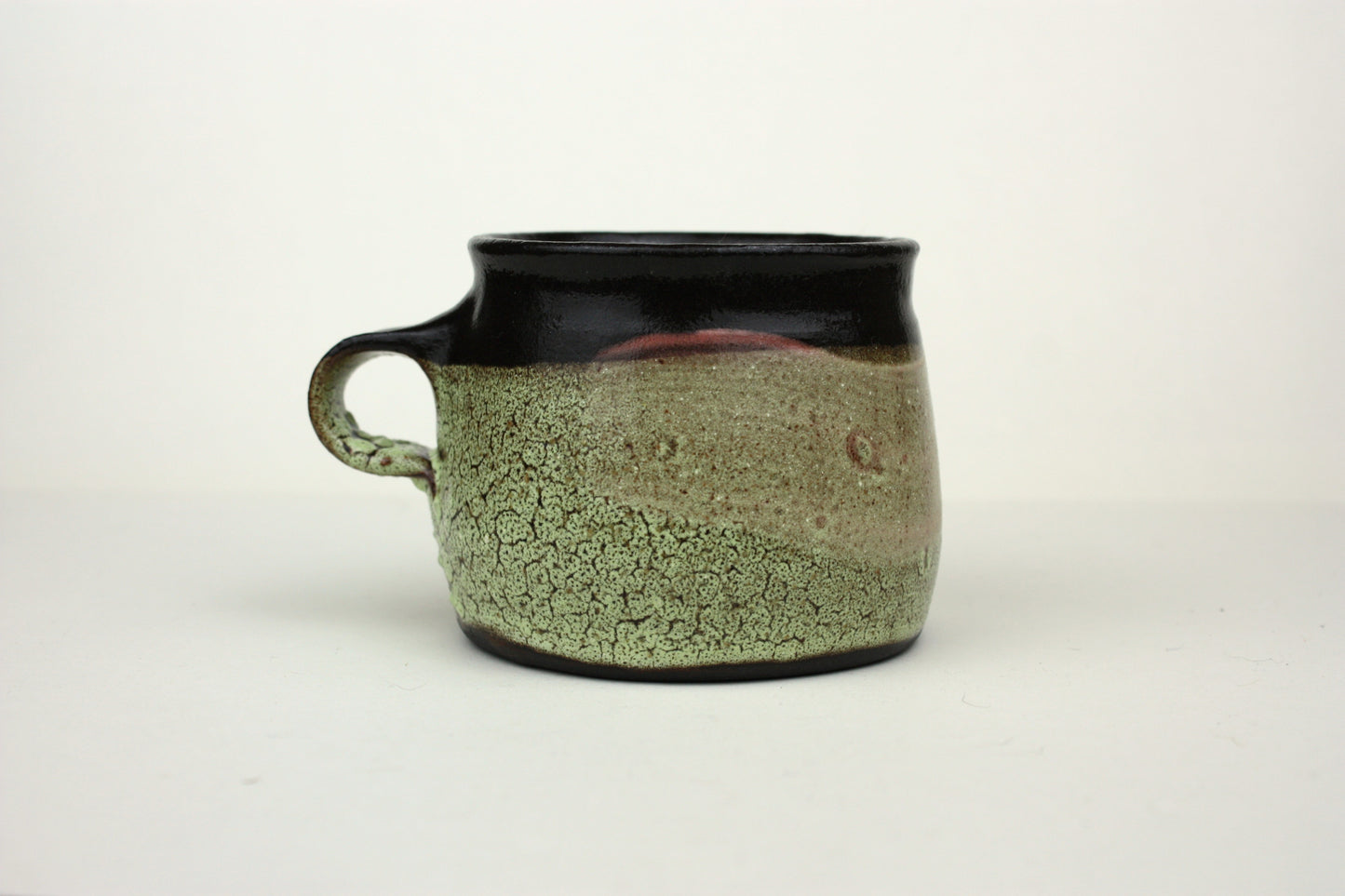 Green crawl glaze mug with pink detail